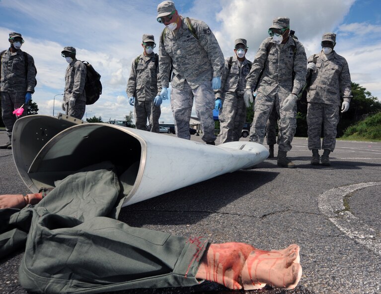 Airmen from the 35th Force Support Squadron execute a search and recovery sweep during a Major Accident Response Exercise at Misawa Air Base, Japan, Sept. 6, 2013. MAREs are implemented to prepare emergency responders for the possibility of real-world accidents. (U.S. Air Force photo by Senior Airman Derek VanHorn)