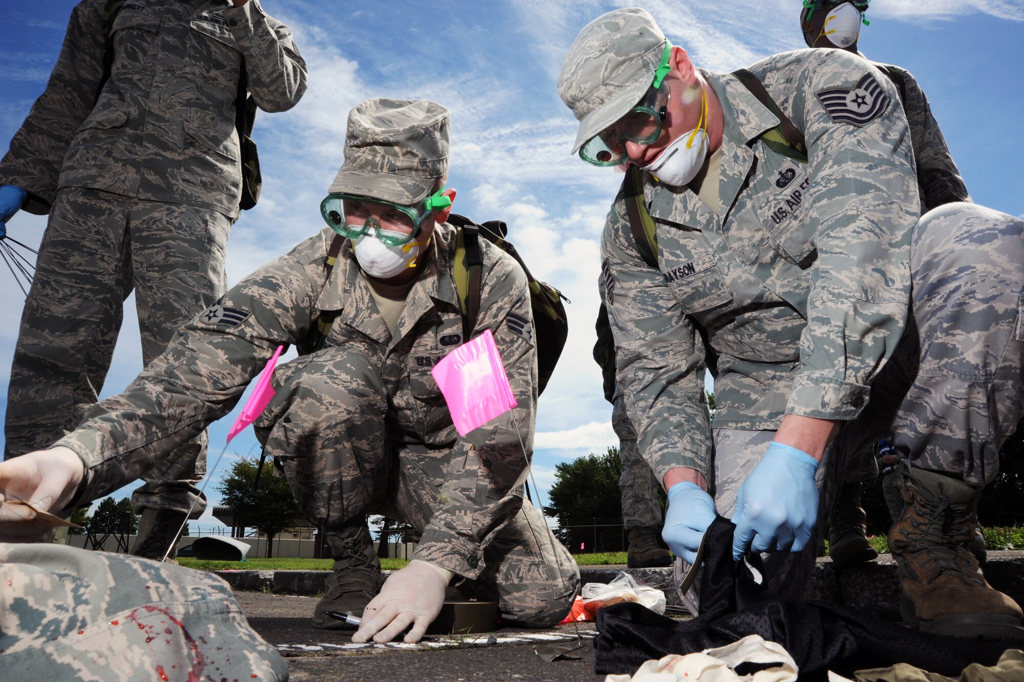 U.S. Air Force Senior Airman Casey Herron, left, and Tech. Sgt. Noah Grayson, 35th Force Support Squadron, mark items leftover from a simulated aircraft accident at Misawa Air Base, Japan, Sept. 6, 2013. The accident was part of a day-long Major Accident Response Exercise. (U.S. Air Force photo by Senior Airman Derek VanHorn)