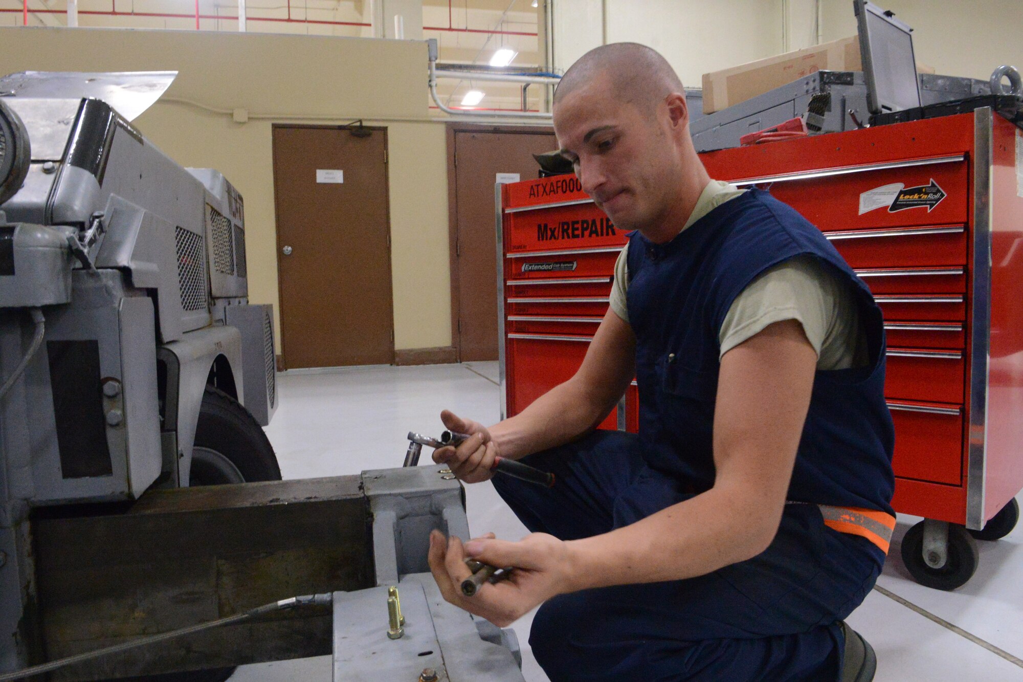 Staff Sgt. Keith Michael, 36th Maintenance Squadron aerospace ground equipment journeyman, replaces an outrigger on a bomb lift during Exercise Beverly Palm 13-05 on Andersen Air Force Base, Guam, Sept. 9, 2013. During the exercise, Andersen Airmen practiced their ability to react, defend and execute operations in a wartime scenario. (U.S. Air Force photo by Airman 1st Class Emily A. Bradley/Released)