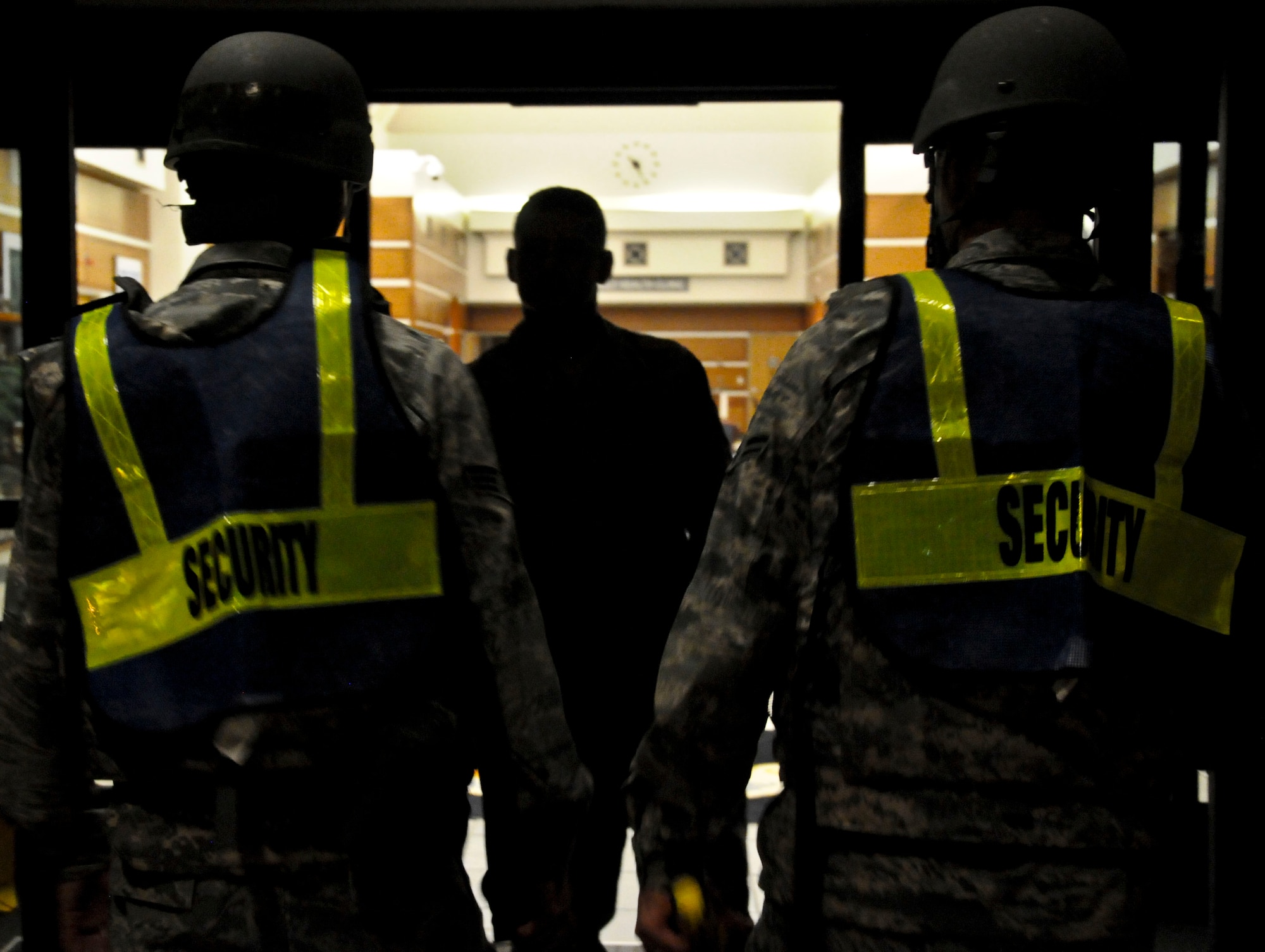 Senior Airman Adam Lloyd (left) and Airman 1st Class Zackary Mannino, 36th Medical Operations Squadron dental technicians, performs a random anti-terrorism measure during Exercise Beverly Palm 13-05 on Andersen Air Force Base, Guam, Sept. 9, 2013. During the exercise, Andersen Airmen practiced their ability to react, defend and execute operations in a wartime scenario. (U.S. Air Force photo by Airman 1st Class Amanda Morris/Released)