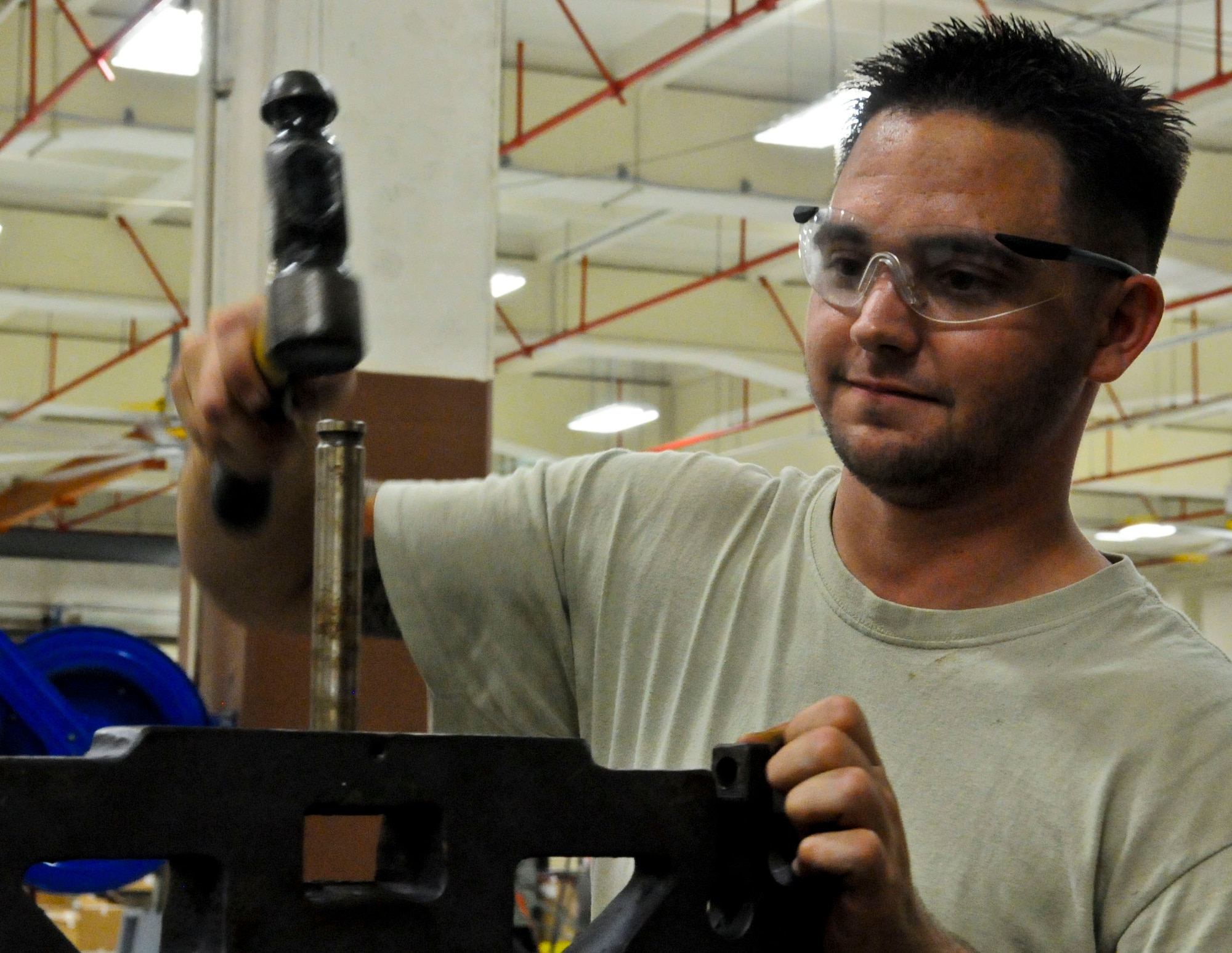 Staff Sgt. Christopher Cacciatore, 36th Maintenance Squadron aerospace ground equipment journeyman, removes a munitions loader manipulator head during Exercise Beverly Palm 13-05 on Andersen Air Force Base, Guam, Sept. 9, 2013. During the exercise, Andersen Airmen practiced their ability to react, defend and execute operations in a wartime scenario. (U.S. Air Force photo by Airman 1st Class Amanda Morris/Released)
