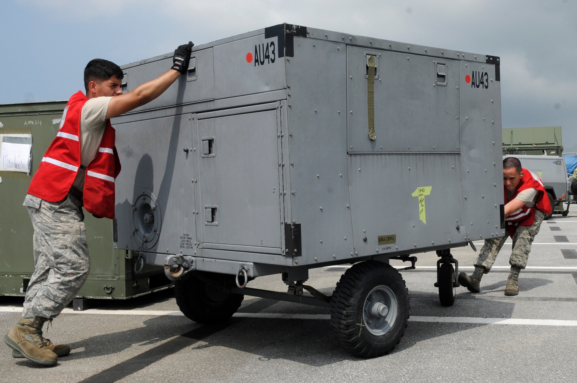 U.S. Air Force Airman 1st Class Bryan Orozco, and Airman Evan Plauche both assigned to the 18th Logistics Readiness Squadron vehicle maintainers, move equipment into position to be palletized for a local operational readiness exercise on Kadena Air Base, Japan, Sept. 9, 2013. Kadena performs LOREs on a regular basis to keep Airmen proficient on mobility, deployment, reception, bedding down of forces, employment and self-aid and buddy care, for possible real-world contingencies. (U.S. Air Force photo by Senior Airman Marcus Morris)