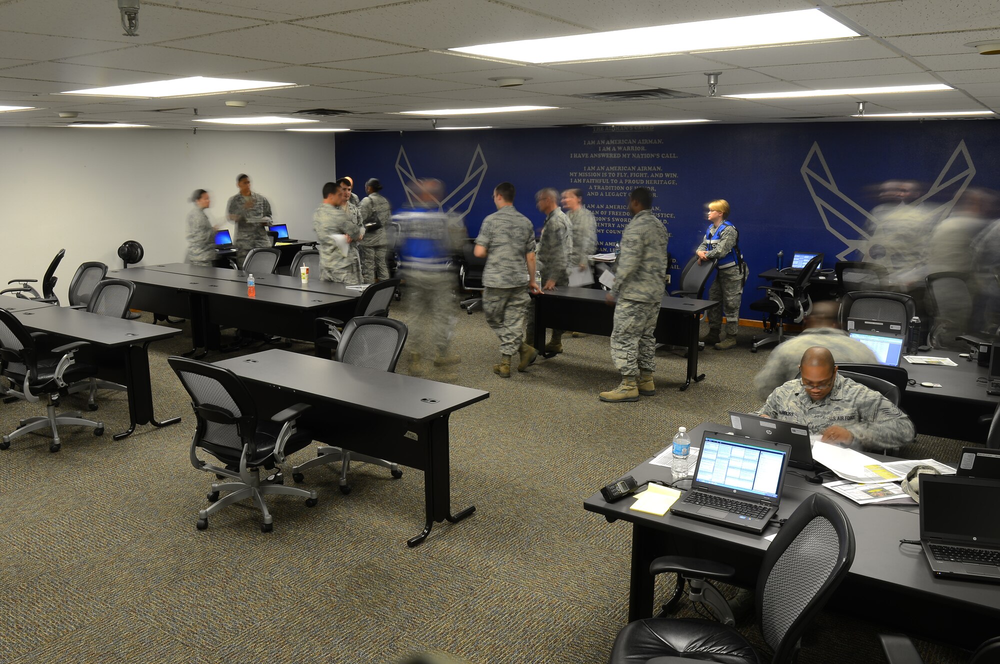 Airmen from the 2nd Bomb Wing work together during an exercise on Barksdale Air Force Base, La., Sept. 5, 2013. During the exercise, key members of Team Barksdale were called to Hoban Hall to form the Initial Response Force. Members in the IRF planned and organized Air Force resources to assess and mitigate a simulated incident. (U.S. Air Force photo/Senior Airman Micaiah Anthony)