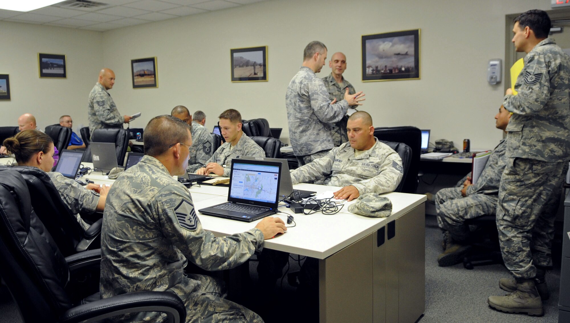 Airmen gather in an Operations Center for simulated incident on Barksdale Air Force Base, La., Sept. 5, 2013. The Operations Center was stood up for specific personnel to communicate with the Initial Response Force and help mitigate the simulated incident. (U.S. Air Force photo/Senior Airman Kristin High)