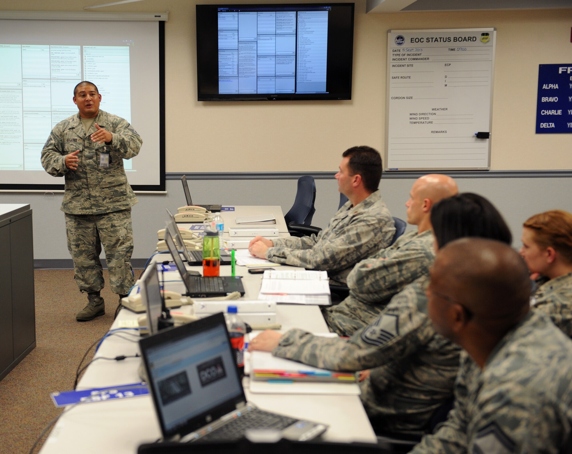 Master Sgt. Benny Baladez, 2nd Civil Engineer Squadron fire chief, discusses the current training incident to the personnel in the Emergency Operations Center on Barksdale Air Force Base, La., Sept. 5, 2013. EOC personnel organize information and report it back to their units to ensure everyone is on the same page and the right course of action is taken to mitigate the incident. (U.S. Air Force photo/Senior Airman Benjamin Gonsier)