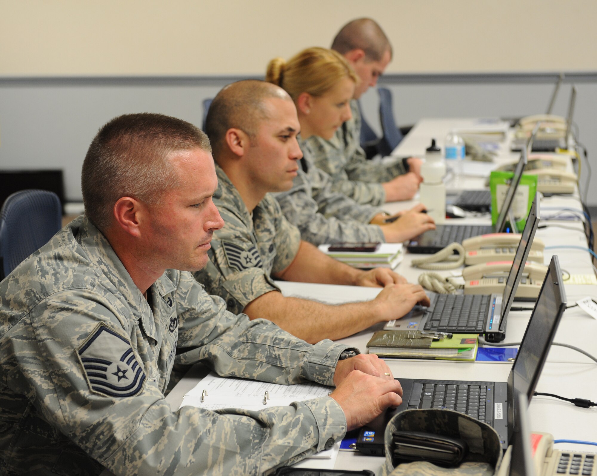 Barksdale Airmen prepare for an Emergency Operations Center briefing on Barksdale Air Force Base, La., Sept. 5, 2013. When an emergency situation occurs, specific base personnel are recalled to the EOC to discuss and organize information about the incident for base leadership. (U.S. Air Force photo/Senior Airman Benjamin Gonsier)