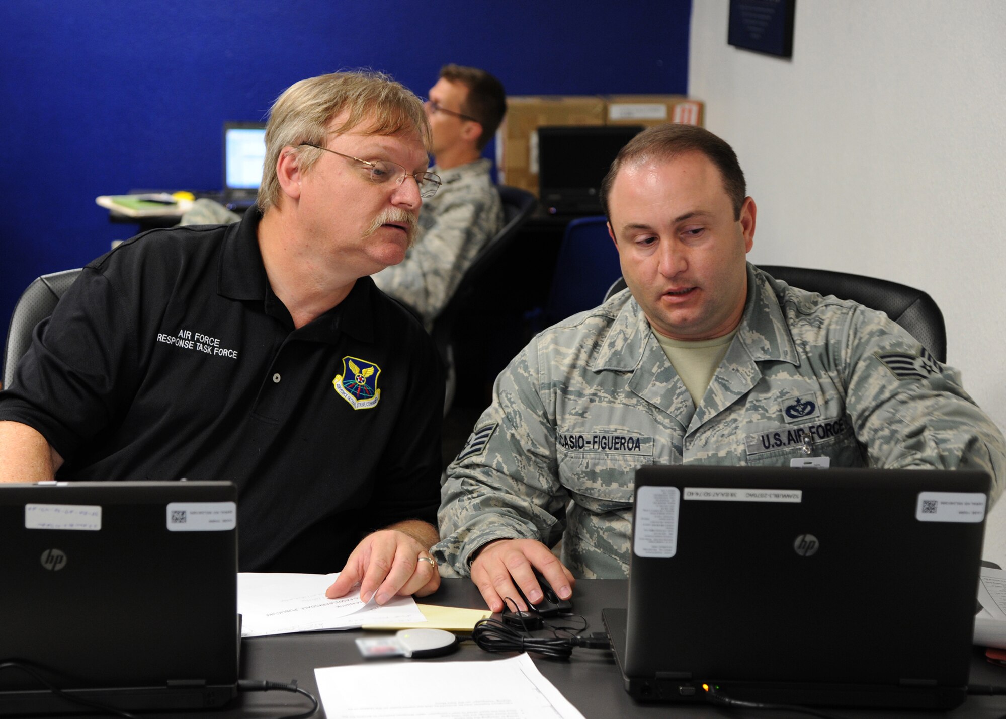 Henry Akin, Air Force Global Strike Command Response Task Force communications coordinator, and Staff Sgt. Carlos Ocasio-Figueroa, 2nd Civil Engineer Squadron Initial Response Force plans section, work together to map out the location of the simulated incident at Hoban Hall on Barksdale Air Force Base, La., Sept. 6, 2013. The map was used to inform key personnel of the area where the simulated incident occurred. (U.S. Air Force photo/Senior Airman Joseph A. Pagán Jr.)