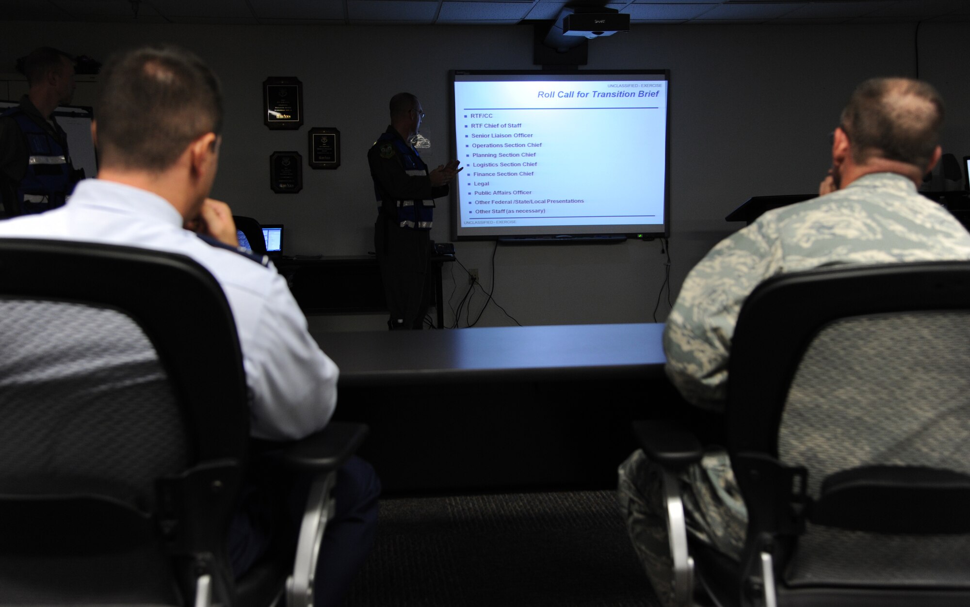 Col. Andrew Gebara, left, 2nd Bomb Wing commander, and Col. John Prater, Air Force Global Strike Command acting response task force chief of staff, listen to details about a simulated incident at Hoban Hall on Barksdale Air Force Base, La., Sept. 6, 2013. The exercise called for personnel from various units around base to set up an Initial Response Force at Hoban Hall to a simulated emergency incident off base. (U.S. Air Force photo/Senior Airman Joseph A. Pagán Jr.)