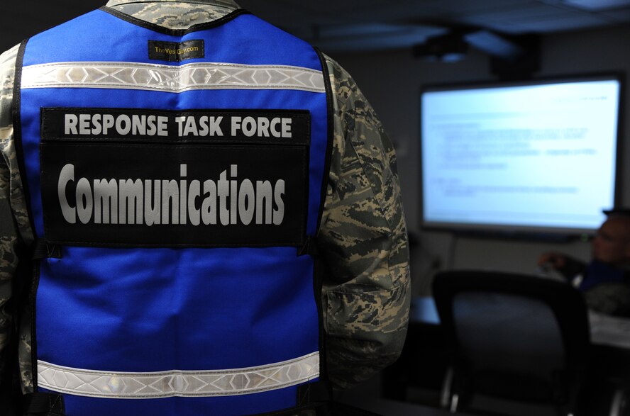 Lt. Col. Julio Gomez, 2nd Communication Squadron commander and communications staff officer, listens to the Initial Response Force and Response Task Force turnover at Hoban Hall on Barksdale Air Force Base, La., Sept. 6, 2013.  Gomez's primary role was to ensure all personnel at the simulated incident site and on Barksdale, had all communication capabilities to support the incident. (U.S. Air Force photo/Senior Airman Joseph A. Pagán Jr.)