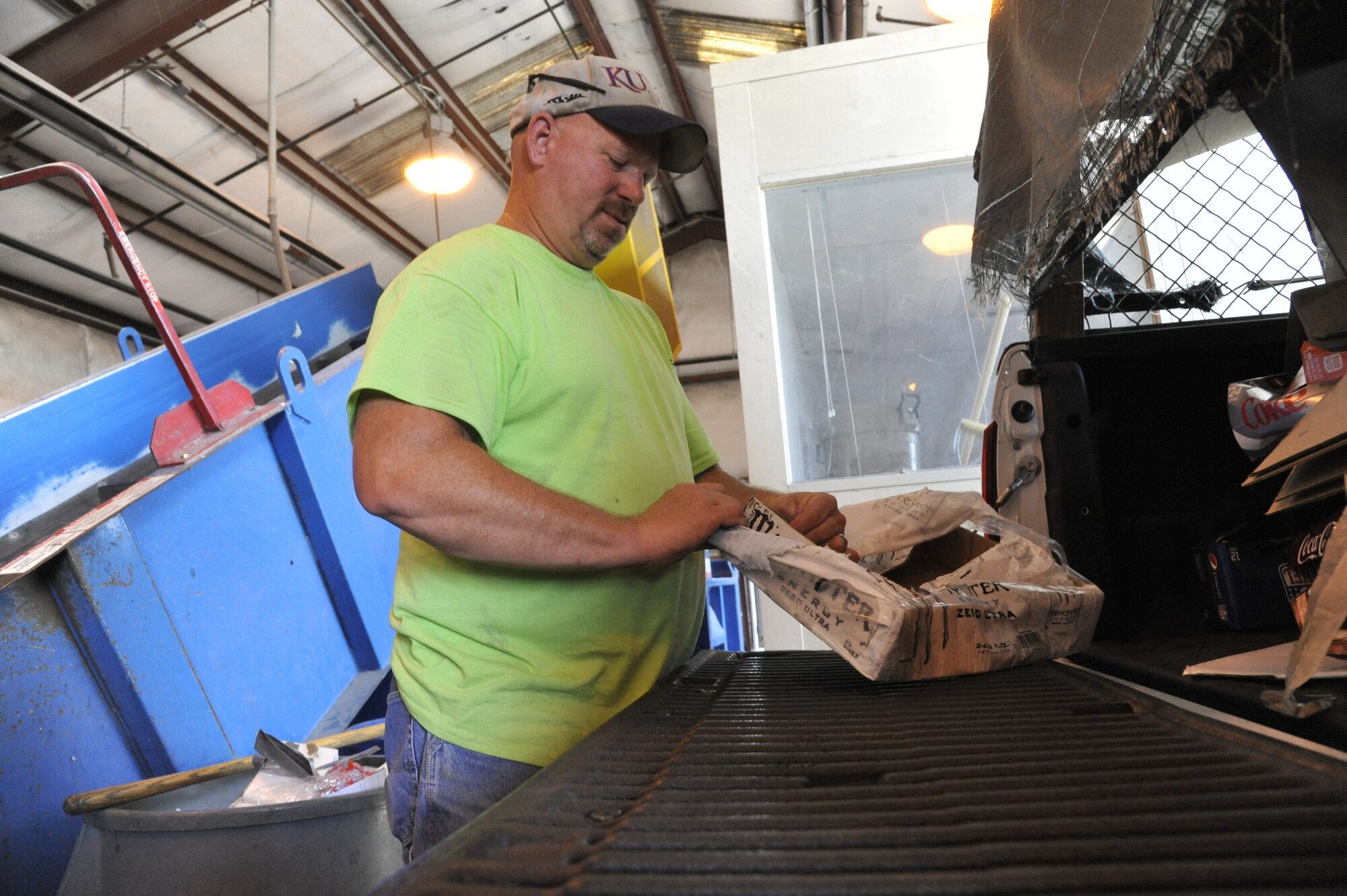 Jeff Willming, 509th Force Support Squadron material examiner and identifier, unloads cardboard from the back of a truck at Whiteman Air Force Base, Mo., Aug. 27, 2013. Recycling center crew members must go around base and collect cardboard from bins and dumpsters in order to condense it and sell it to companies. (U.S. Air Force photo by Airman 1st Class Keenan Berry/Released)

