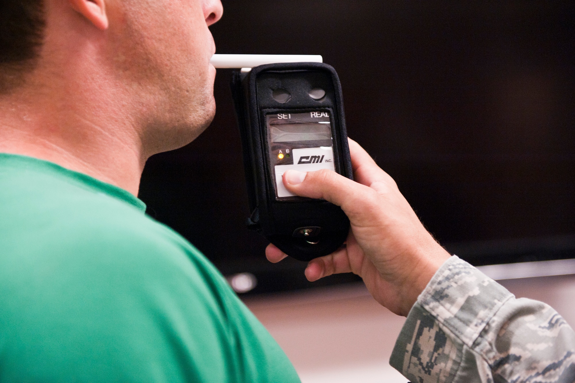 A volunteer blows into a breathalyzer during a driving under intoxication training at the 1st Special Operations Security Forces Squadron on Hurlburt Field,Fla., Sept. 5, 2013. The annual training was designed to refresh security forces members on detecting impaired drivers.  (U.S. Air Force photo by Senior Airman Krystal M. Garrett)