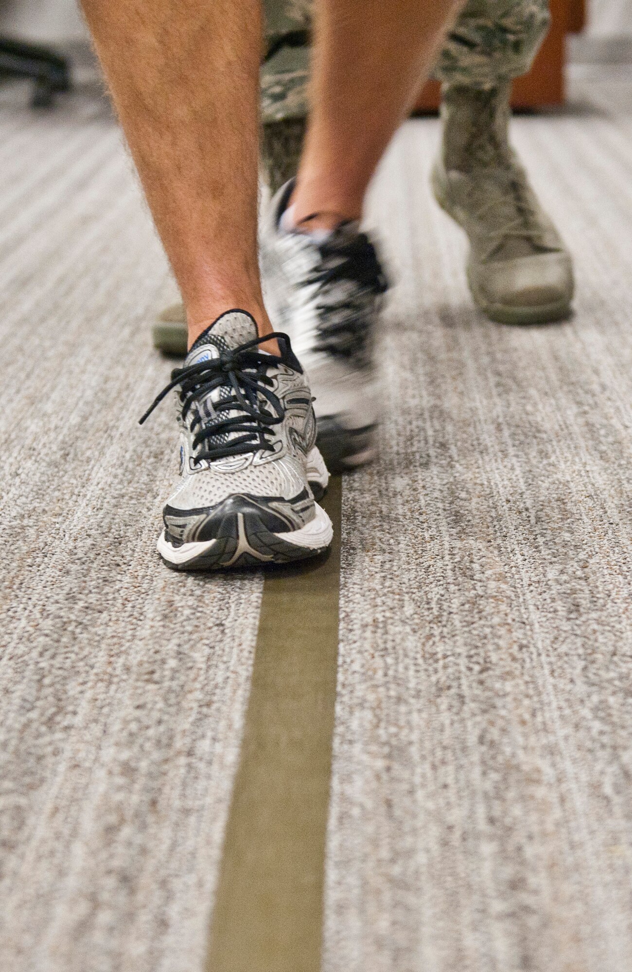A volunteer performs the walk and turn sobriety test during a driving under the influence training at the Security Forces Squadron on Hulrburt Field, Fla., Sept. 5, 2013. During the Walk-and-Turn test, the subject is directed to take nine steps, heel-to-toe, along a straight line. After taking the steps, the suspect must turn on one foot and return in the same manner in the opposite direction. (U.S. Air Force photo by Senior Airman Krystal M. Garrett)