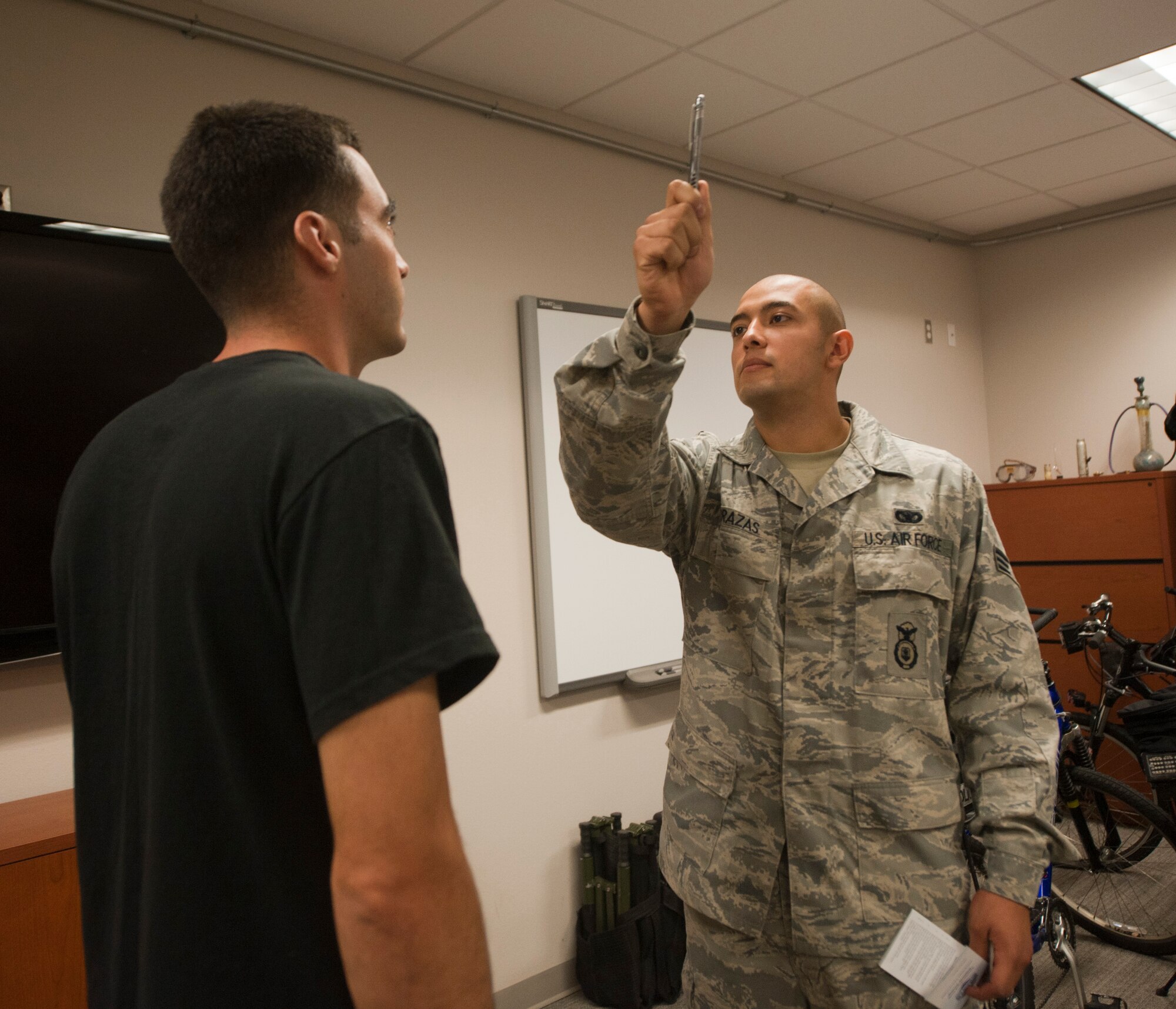 Senior Airman Anthony Terrazas, 1st Special Operations Security Forces K-9 handler, administers a horizontal gaze nystagamas test on a volunteer during a driving under the influence training at the security forces squadron on Hulrburt Field, Fla., Sept. 5, 2013. The training placed intoxicated volunteers in a controlled environment with security forces personnel. Then, defenders administered several field sobriety tests to the volunteers.  (U.S. Air Force photo by Senior Airman Krystal M. Garrett)