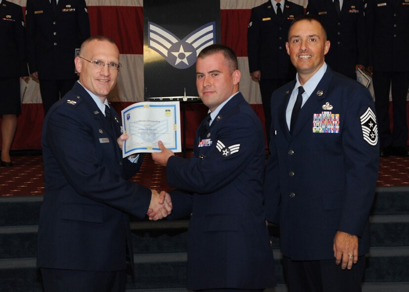 Senior Airman Joshua Wilcken, 2nd Security Forces Squadron, receives a certificate of promotion from Col. Michael Adderley, 2nd Operations Group commander, and Chief Master Sgt. Curtis Storms, 2nd Bomb Wing command chief, during the August Wing Promotion Ceremony on Barksdale Air Force Base, La., Aug. 29, 2013. (U.S. Air Force photo/Senior Airman Joseph A. Pagán Jr.)