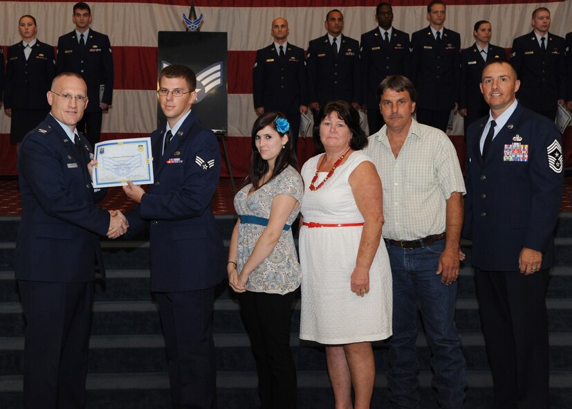 Senior Airman Joshua Walker, 2nd Maintenance Squadron, receives a certificate of promotion from Col. Michael Adderley, 2nd Operations Group commander, and Chief Master Sgt. Curtis Storms, 2nd Bomb Wing command chief, during the August Wing Promotion Ceremony on Barksdale Air Force Base, La., Aug. 29, 2013. (U.S. Air Force photo/Senior Airman Joseph A. Pagán Jr.)