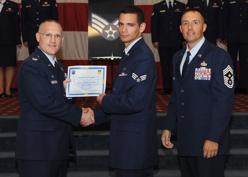 Senior Airman Ulises Valdivia-Gutierrez, 2nd Maintenance Squadron, receives a certificate of promotion from Col. Michael Adderley, 2nd Operations Group commander, and Chief Master Sgt. Curtis Storms, 2nd Bomb Wing command chief, during the August Wing Promotion Ceremony on Barksdale Air Force Base, La., Aug. 29, 2013. (U.S. Air Force photo/Senior Airman Joseph A. Pagán Jr.)
