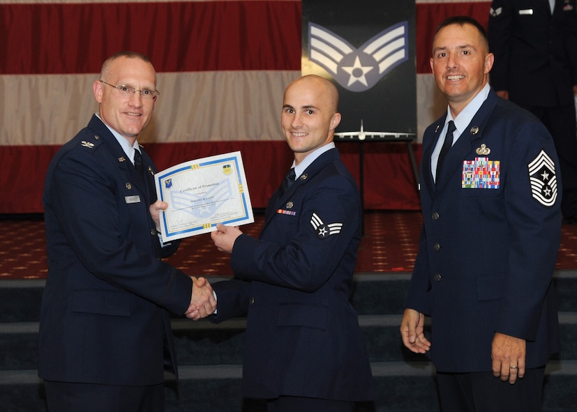 Senior Airman Jeromy Cato, 2nd Maintenance Squadron, receives a certificate of promotion from Col. Michael Adderley, 2nd Operations Group commander, and Chief Master Sgt. Curtis Storms, 2nd Bomb Wing command chief, during the August Wing Promotion Ceremony on Barksdale Air Force Base, La., Aug. 29, 2013. (U.S. Air Force photo/Senior Airman Joseph A. Pagán Jr.)