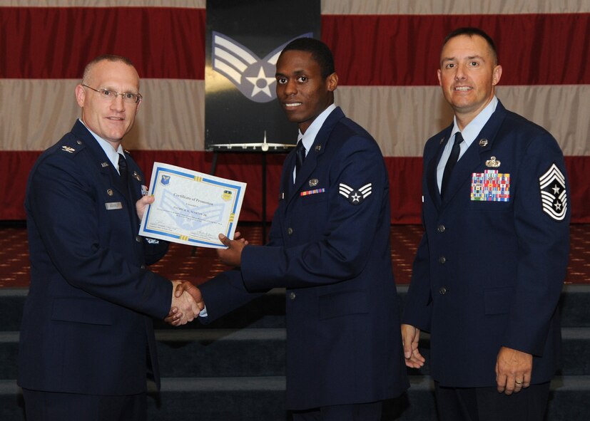 Senior Airman Patrick Martin, 2nd Logistics Readiness Squadron, receives a certificate of promotion from Col. Michael Adderley, 2nd Operations Group commander, and Chief Master Sgt. Curtis Storms, 2nd Bomb Wing command chief, during the August Wing Promotion Ceremony on Barksdale Air Force Base, La., Aug. 29, 2013. (U.S. Air Force photo/Senior Airman Joseph A. Pagán Jr.)