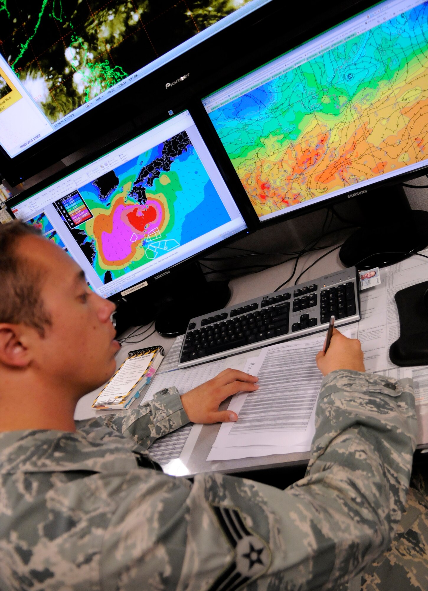 Senior Airman Corrington Wheeler, 18th Operations Support Squadron, weather technician, completes a duty checklist on Kadena Air Base, Sept. 9, 2013. These shift duty checklists are updated hourly to provide current weather situations to wing leadership for planning operations throughout the Pacific theater.  (U.S. Air Force photo by Staff Sgt. Laszlo Babocsi)