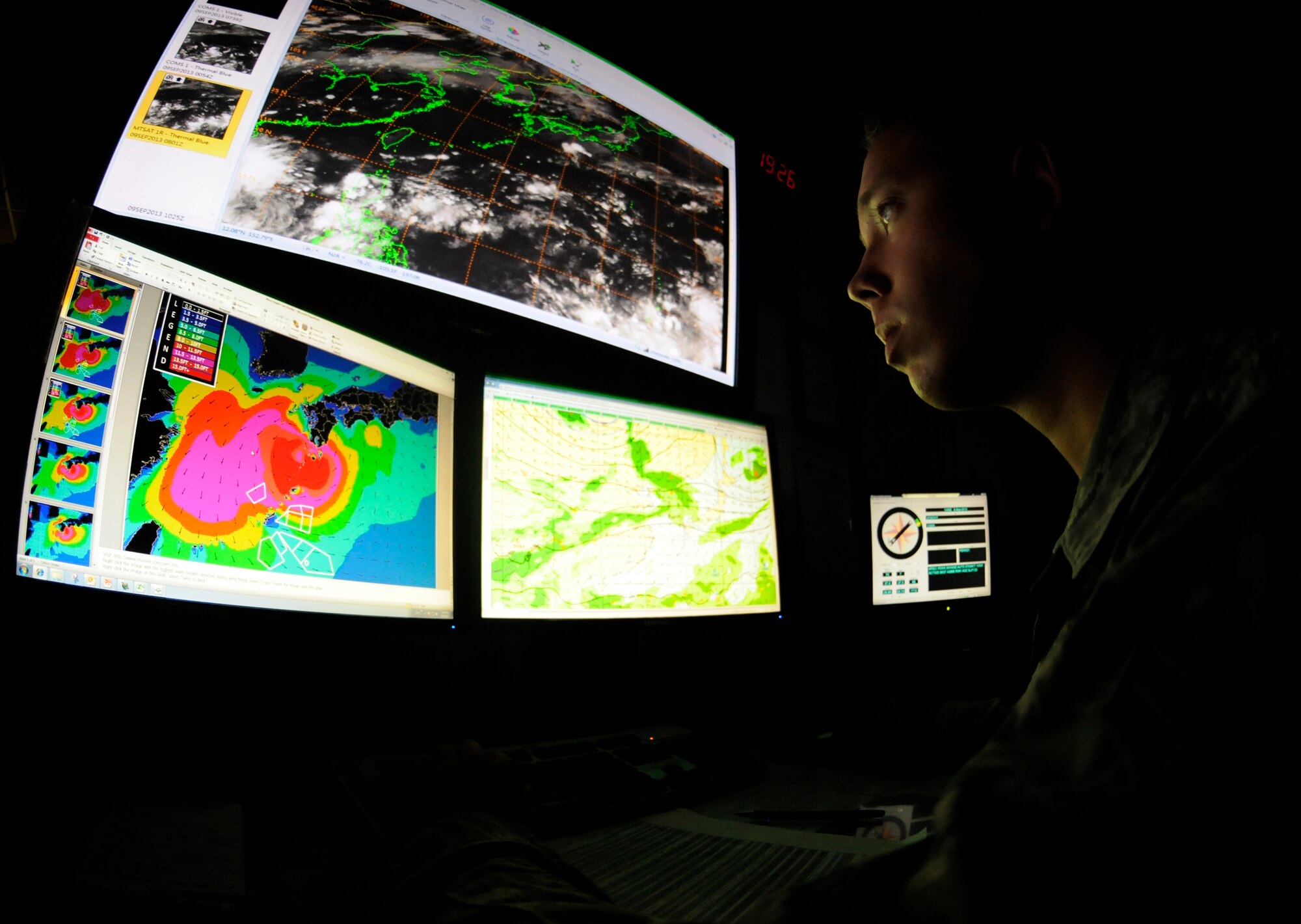 Senior Airman Corrington Wheeler, 18th Operations Support Squadron, weather technician, monitors satellite and radar weather patterns throughout the Pacific area of response on Kadena Air Base, Sept. 9, 2013. This mission is vital to Kadena’s role in launching and recovering aircraft during possible operations in the Pacific theater.  (U.S. Air Force photo by Staff Sgt. Laszlo Babocsi)