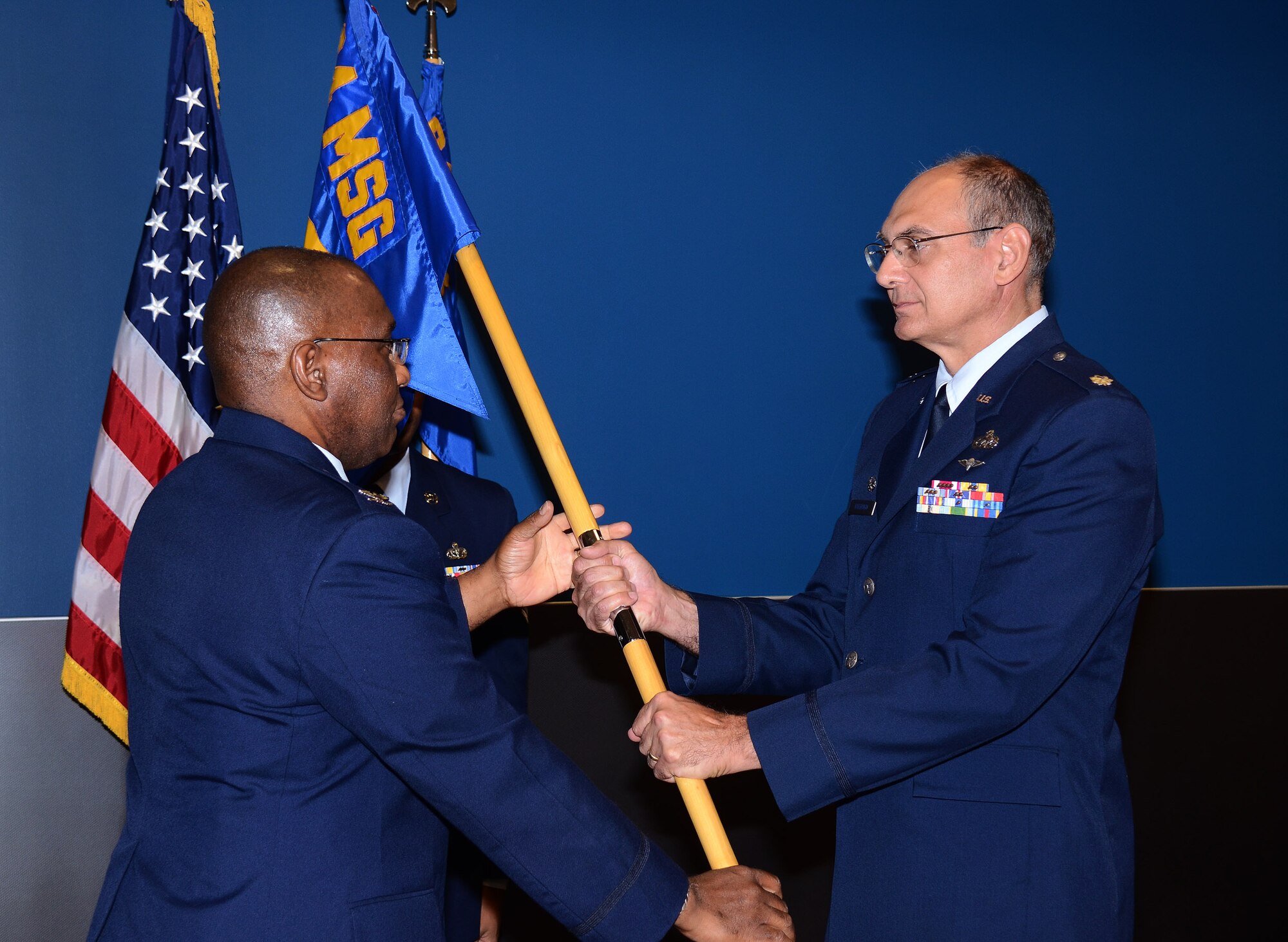 Col. Marshal Irvin Jr., 94th Mission Support Group commander passes the 94th Logistics Readiness Squadron flag to Lt. Col. John Vallrugo during a Change of Command ceremony at Dobbins Air Reserve Base, Ga., Sept. 7.  (U.S. Air Force photo/ Brad Fallin)