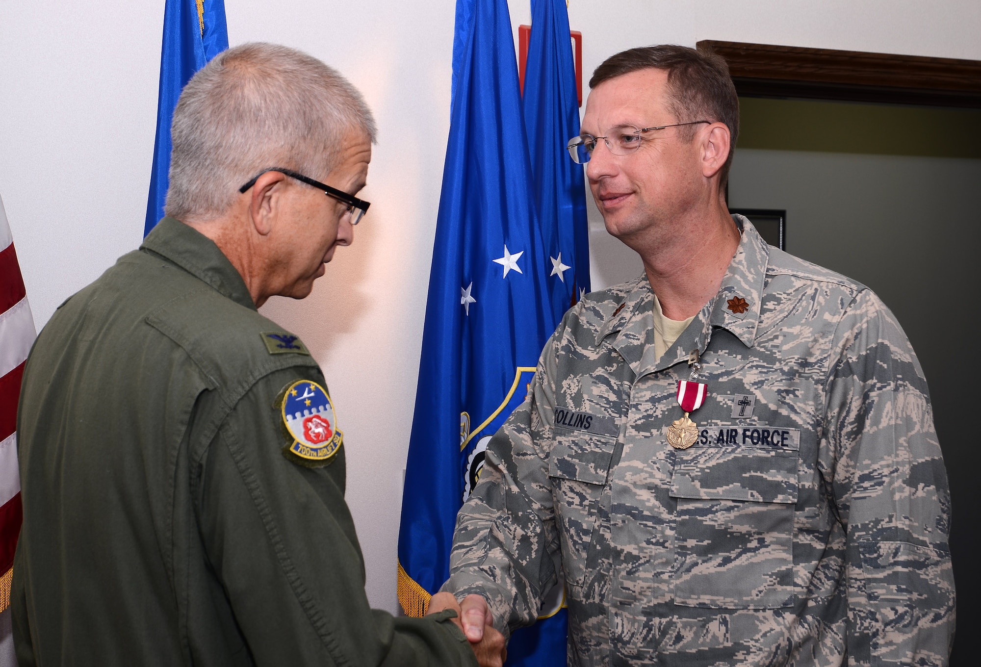 Col. Tim Tarchick, 94th Airlift Wing commander, presents Chaplain (Maj.) Douglas A. Collins with the Meritorious Service Medal, First Oak Leaf Cluster Sept.8 for outstanding professional skill, leadership and ceaseless efforts to support the Airmen and families of the 94th Airlift Wing during his Sept. 9, 2005 to Jan. 2013 tenure.