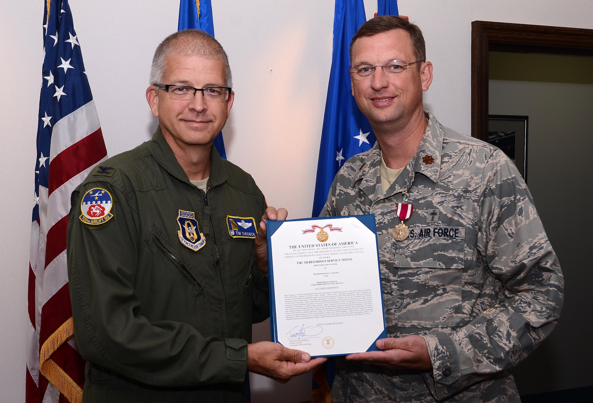 Col. Tim Tarchick, 94th Airlift Wing commander, presents Chaplain (Maj.) Douglas A. Collins with the Meritorious Service Medal, First Oak Leaf Cluster Sept.8 for outstanding professional skill, leadership and ceaseless efforts to support the Airmen and families of the 94th Airlift Wing during his Sept. 9, 2005 to Jan. 2013 tenure.