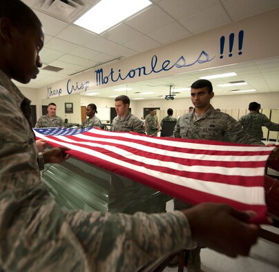 Moody Honor Guard ceremonial guardsmen practice folding the flag Sept. 6, 2013, at Moody Air Force Base, Ga. The flag is folded and given to the next-of-kin at the funeral, along with a message of condolence. (U.S. Air Force photo by Airman 1st Class Sandra Marrero/released) 