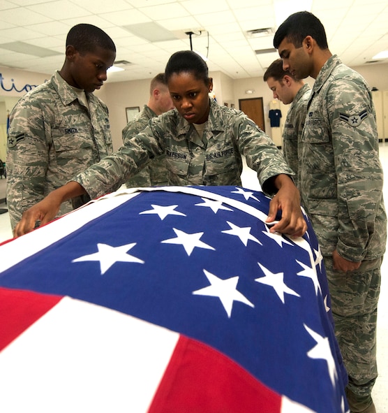 U.S. Air Force Senior Airman Tiffany Dickerson, Moody Honor Guard ceremonial guardsman performs a dressing sequence during training at Moody Air Force Base, Ga., Sept. 6, 2013. The dressing sequence a series of movements used to prepare the team to remove the casket from the hearse. (U.S. Air Force photo by Airman 1st Class Sandra Marrero/released)