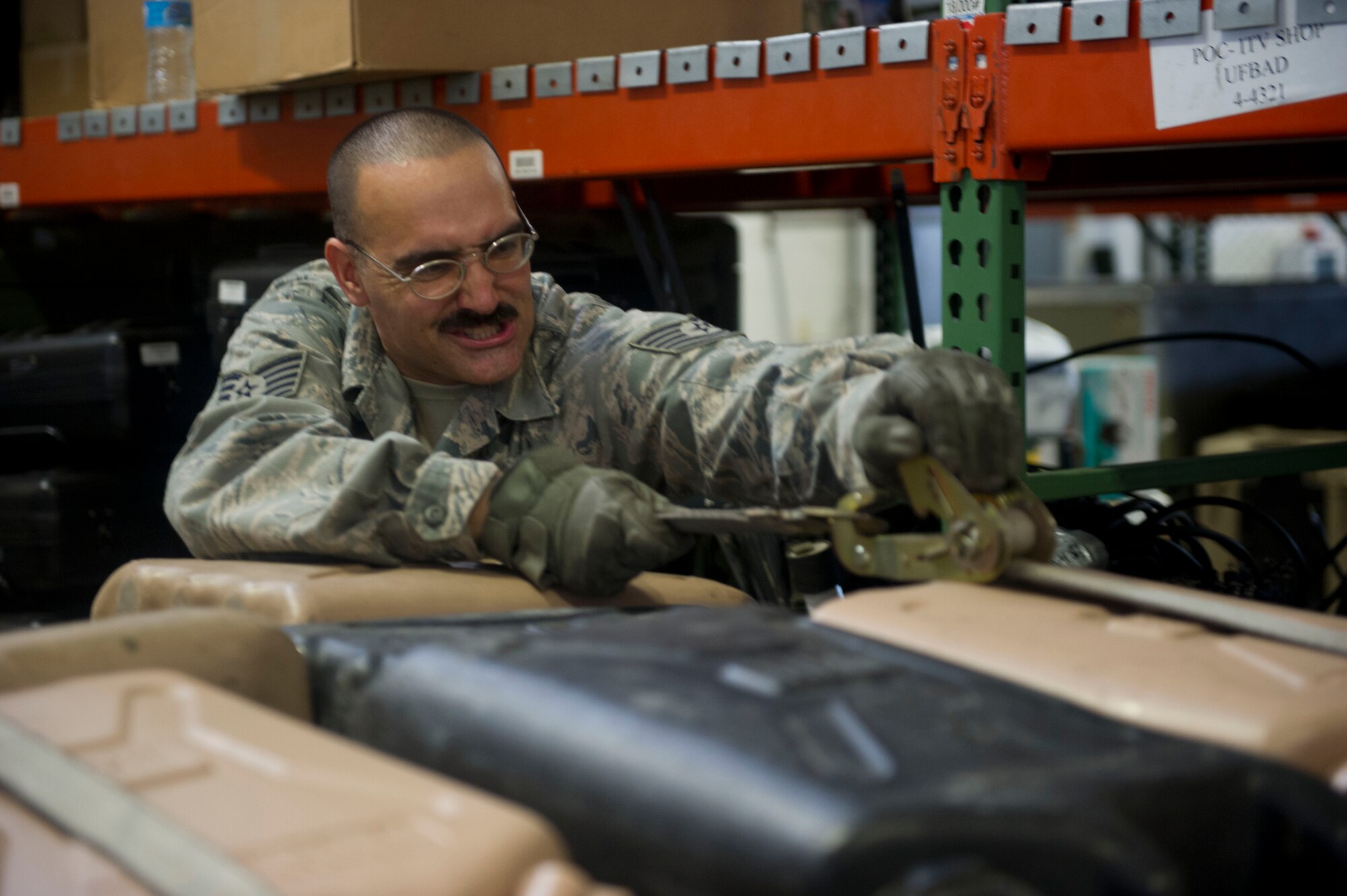 JOINT BASE MCGUIRE-DIX-LAKEHURST, N.J. - Tech. Sgt. Matthew Powers, 819th Global Support Squadron, secures equipment to help clean out the Global Reach Deployment Center, here, Aug. 7, 2013. (U.S. Air Force photo by Staff Sgt. Gustavo Gonzalez)
