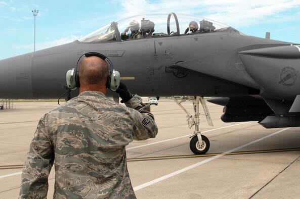 U.S. Air Force Staff Sgt. Jason Williams, 4th Aircraft Maintenance Squadron crew chief, salutes as Capt. John Walsh, 336th Fighter Squadron pilot, and Maj. Gen. Jake Polumbo, 9th Air Force commander, taxi onto the runway at Seymour Johnson Air Force Base, N.C., Aug. 22, 2013.  Polumbo flew a training mission with the 336th FS “Rocketeers.”  (U.S. Air Force photo by Airman 1st Class Brittain Crolley)
