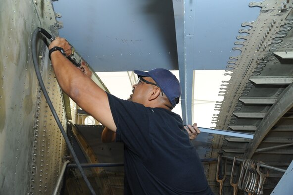 Rudy Rodriguez, 902nd Mission Support Group Trainer Development Division welder, attaches parts to the interior of what will be a C-17 Aeromedical Trainer Aug. 19 at Joint Base San Antonio-Randolph.  (U.S. Air Force photo by Rich McFadden/released)
