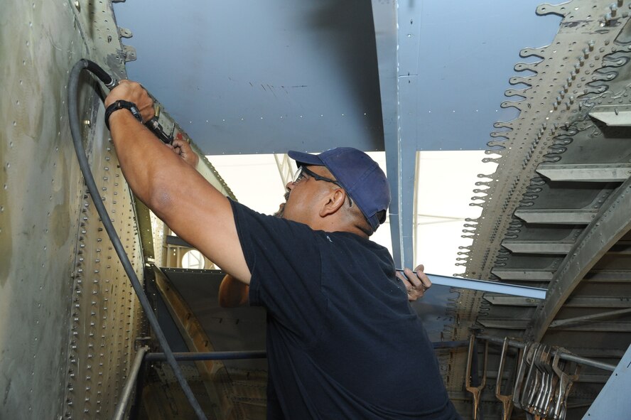 Rudy Rodriguez, 902nd Mission Support Group Trainer Development Division welder, attaches parts to the interior of what will be a C-17 Aeromedical Trainer Aug. 19 at Joint Base San Antonio-Randolph.  (U.S. Air Force photo by Rich McFadden/released)