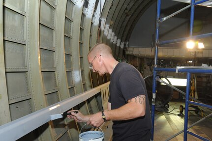 Ricky Frantz, 902nd Mission Support Group Trainer Development Division sheet metal mechanic and painter, paints the interior of what will be a C-17 Aeromedical Trainer Aug. 19 at Joint Base San Antonio-Randolph.  (U.S. Air Force photo by Rich McFadden/released) 
