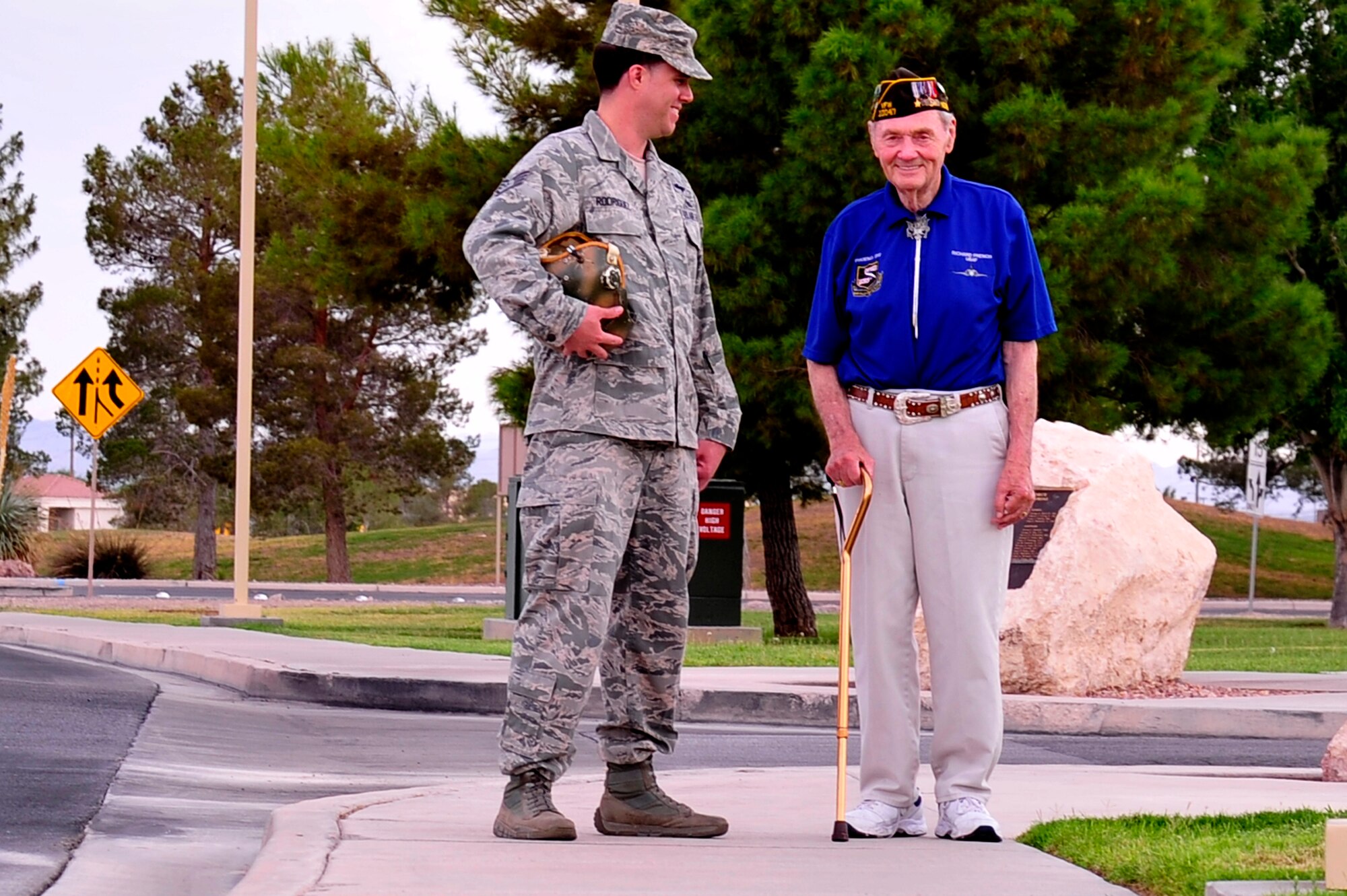 Staff Sgt. Jose Rodriguez, 99th Air Base Wing aerial radio television broadcaster, shares a laugh with retired Lt. Col. Richard E. French, a former U.S. Air Force fighter pilot, who recalls always wanting to fly with a camera crew during an interview at Nellis Air Force Base, Nev., Aug. 20. French shared his experiences with Nellis and Creech Airmen as part of his continued service to the U.S. Air Force. (U.S. Air Force photo by Staff Sgt. N.B.)
