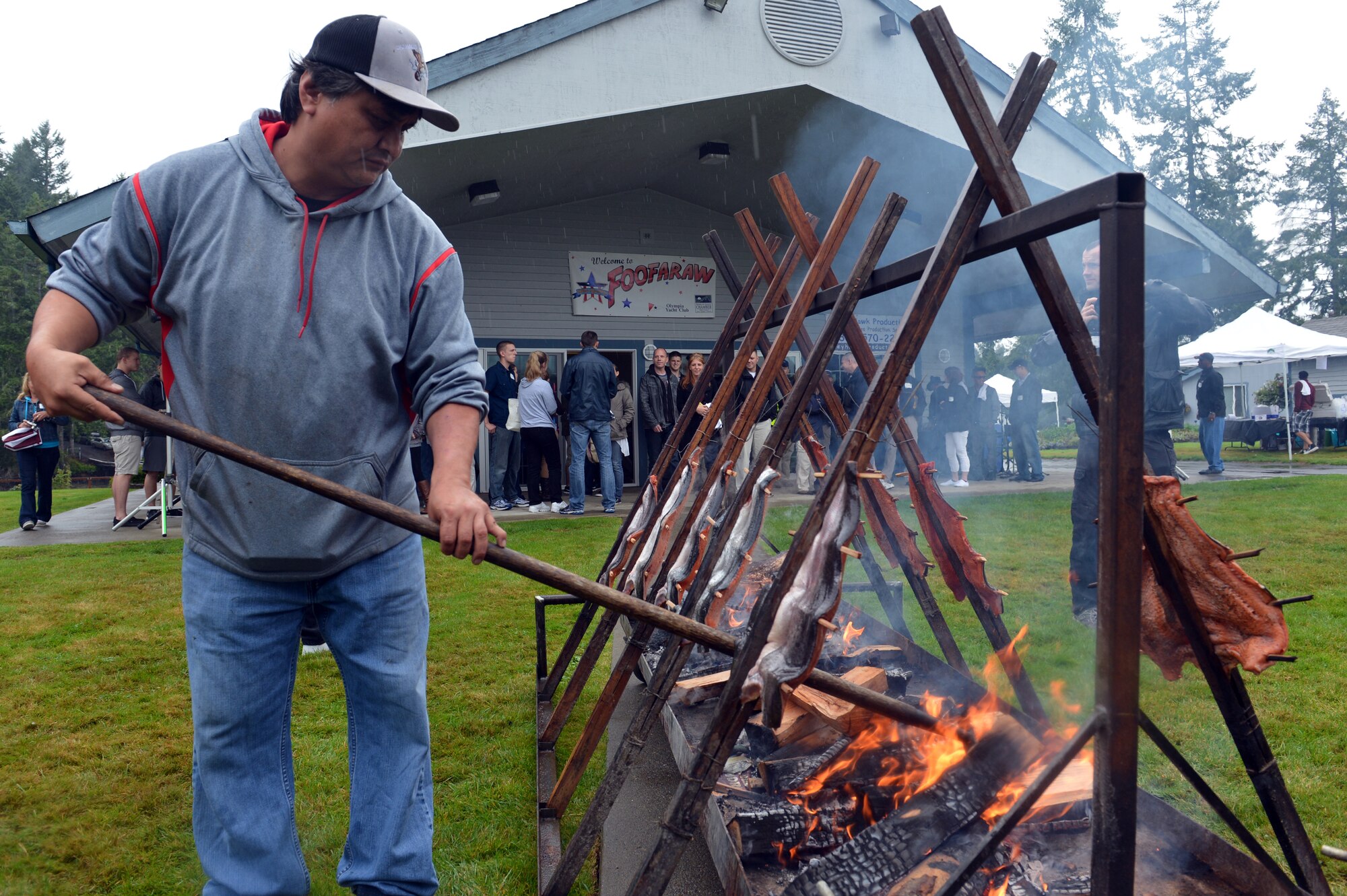Darrin Jones, Lucky Eagle Casino tribal gaming agent, stirs the alder-wood logs that smoke the salmon filets at Foof-a-raw, Sept. 6, 2013 at Olympia, Wash. This is the 51st year Foofaraw and community partners have given back to local military members. (U.S. Air Force photo/Staff Sgt. Jason Truskowski)