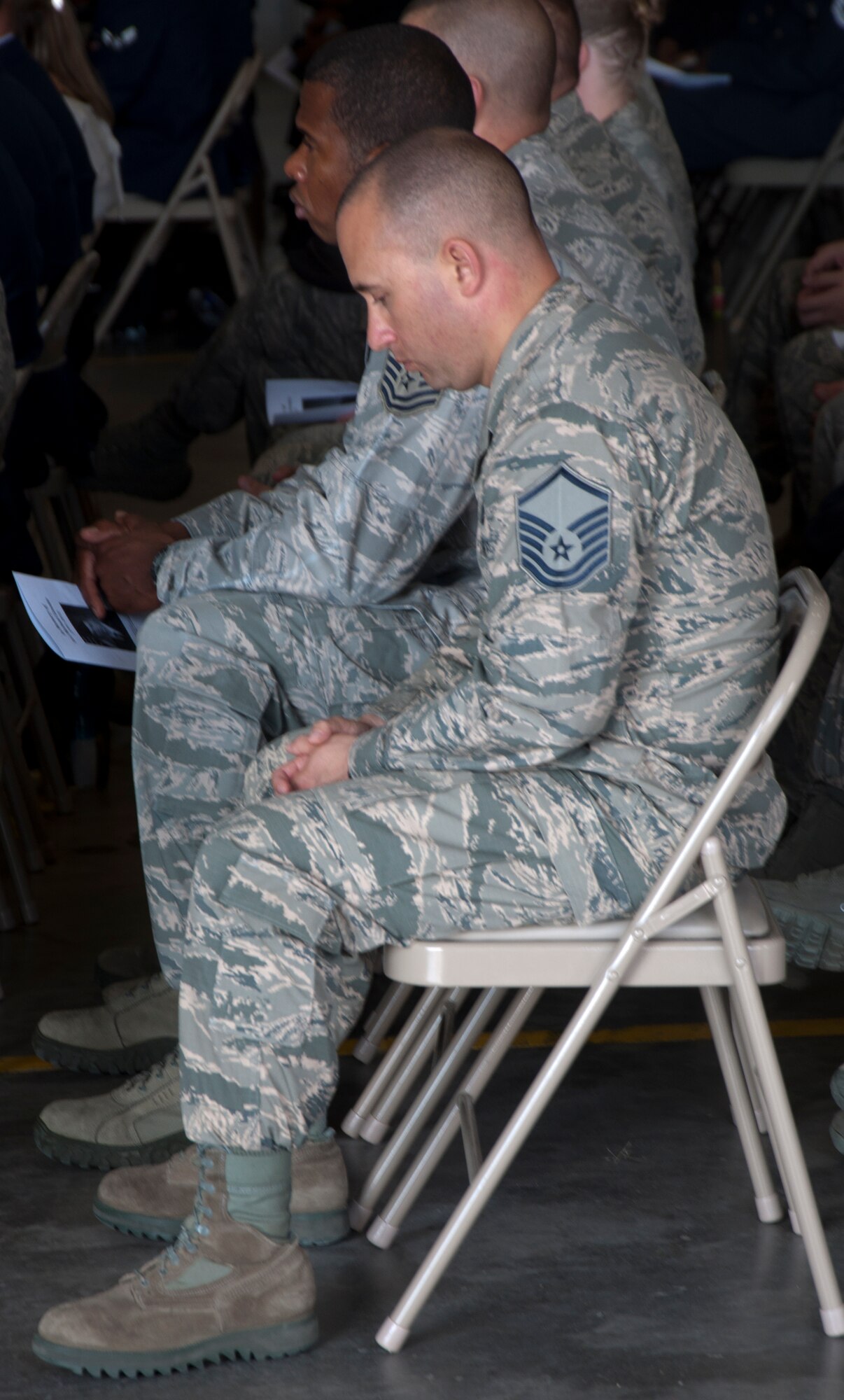 130906-F-GZ967-008 During a memorial service held for Senior Airman Michael Gnoato Sept. 6, 2013, in the Peacekeeper High Bay, Bldg. 1501, F.E. Warren Air Force Base, Wyo., Airman bow their heads in respect as they remember his life and his time in the Air Force.  (U.S. Air Force photo by Airman 1st Class Brandon Valle)