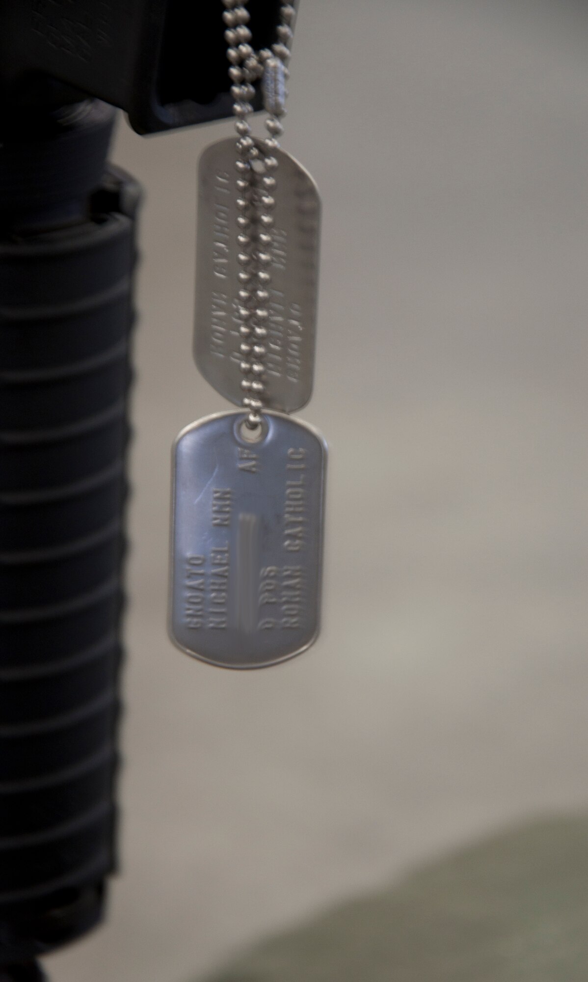 130906-F-CP693-020 Senior Airman Michael Gnoato’s dog tags hang from a battle cross during his memorial Sept. 6, 2013. The battle cross consists of an M4-A1 assault rifle, placed inside a pair of combat boots, with a helmet resting on top. (U.S. Air Force photo illustration by 1st Lt. Eydie Sakura)