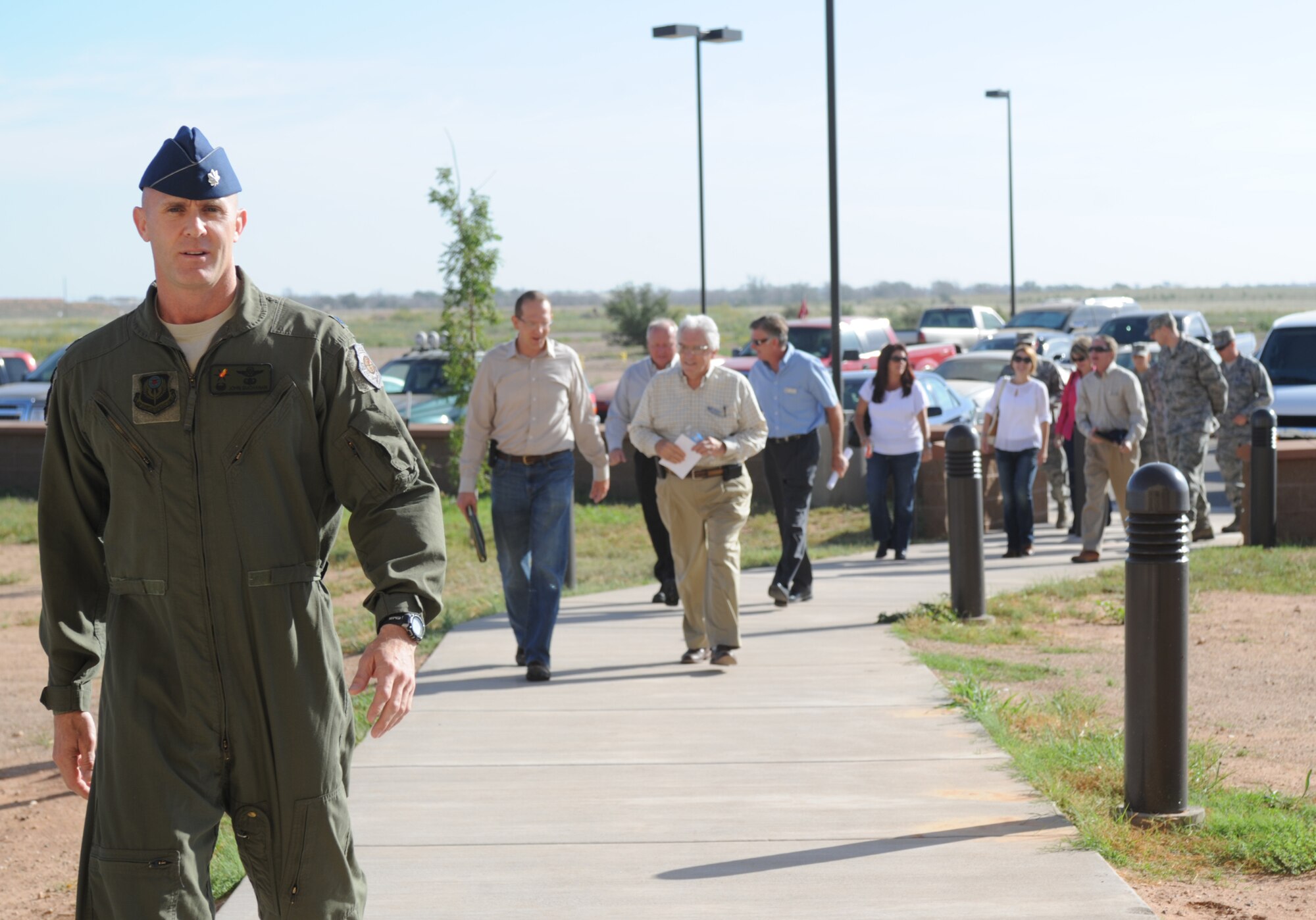 U.S. Air Force Lt. Col. John Buchanan, 522nd Special Operations Squadron commander, leads a group of honorary commanders into the 522 SOS as part of a tour Aug. 29, 2013 at Cannon Air Force Base, N.M. The 27th Special Operations Wing Honorary Commander Program serves as a critical link between local and military leaders. (U.S. Air Force photo/Senior Airman Ericka Engblom)
