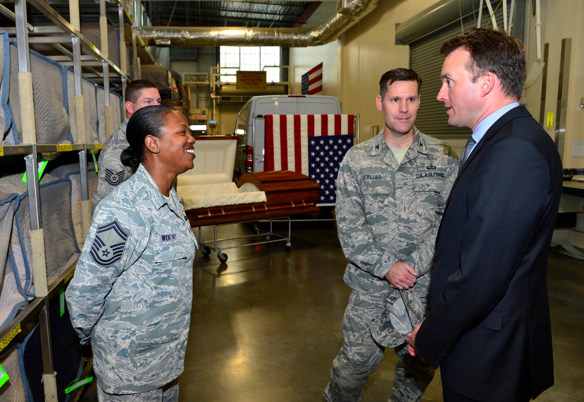 Acting Secretary of the Air Force Eric K. Fanning receives a brief from Col. John Devillier (center), Armed Forces Mortuary Affairs Operations commander, and Senior Master Sgt. Antoinette D. Worthey, departures NCO in charge, at Dover Air Force Base, Del. Sept. 5, 2013. The Acting SecAF is visiting Air Force bases to speak with Airmen about the Air Force and its future.  (U.S. Air Force photo/David S. Tucker)

