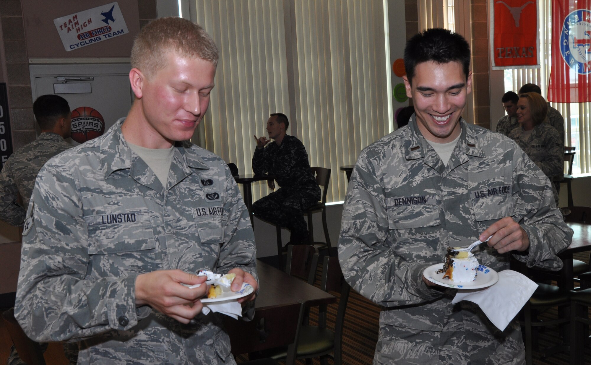 GOODFELLOW AIR FORCE BASE, Texas – Airman 1st Class Jared Lunstad, 17th Civil Engineer Squadron emergency management specialist and Combined Federal Campaign unit representative, and 2nd Lt. Paul Dennison, 17th CES programmer and CFC unit representative, eat a piece cake at the Event Center Sept. 5. Lunstad said he is eager to start collecting donations for the CFC and wants to raise $5,000 within his unit. (U.S. Air Force photo/ Airman 1st Class Joshua Edwards)