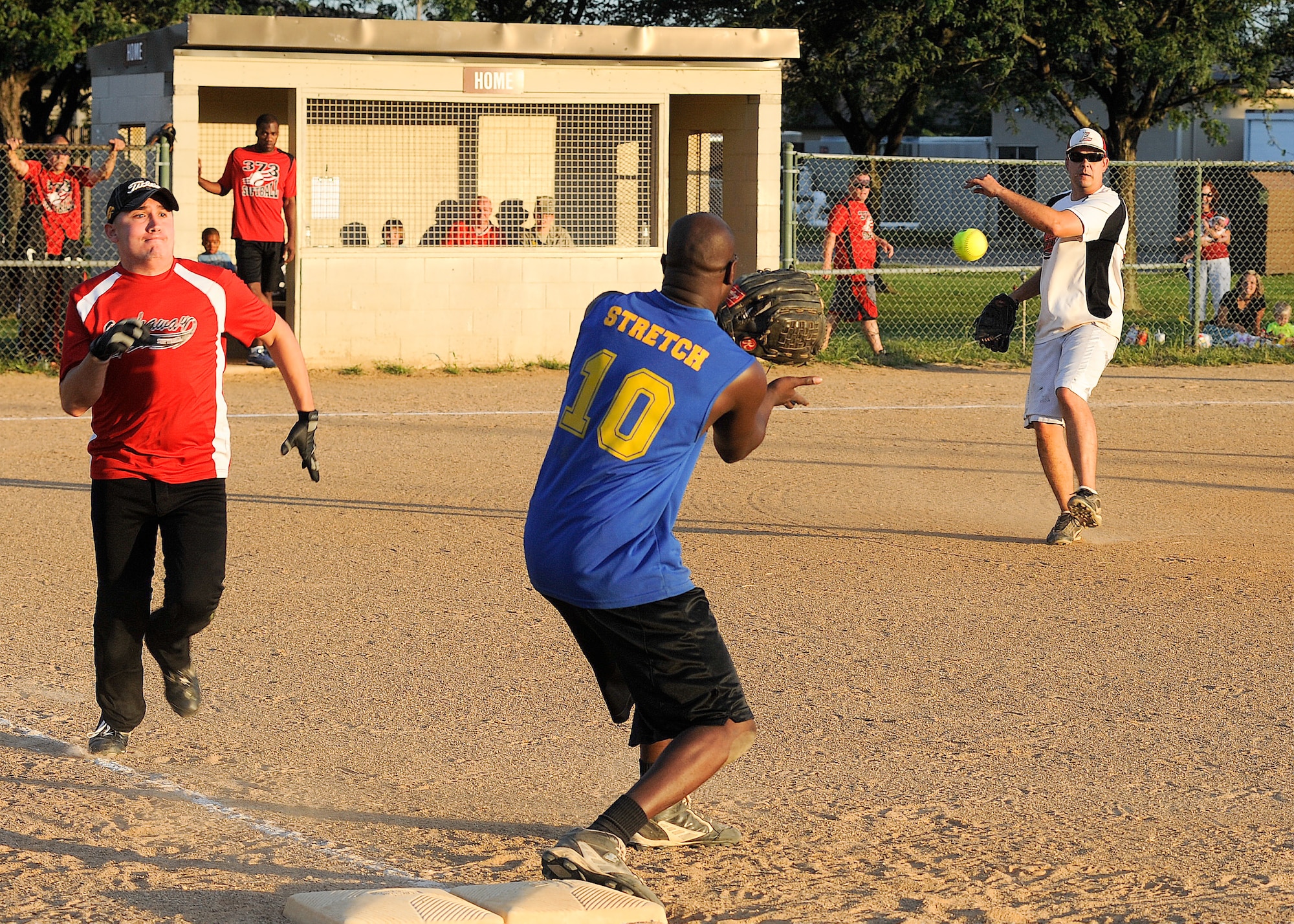 Matthew Morrison, 436th Aircraft Maintenance Squadron pitcher, throws the ball to first base while Jason Vazquez, 373rd Training Squadron/Maintenance Operations Squadron, attempts to beat the throw during the softball championship Sept. 4, 2013, at the softball field on Dover Air Force Base, Del. The 436th AMXS defeated the 373rd TRS/MOS to win the title. (U.S. Air Force photo/Senior Airman Jared Duhon)