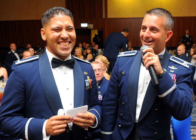 SPANGDAHLEM AIR BASE, Germany – U.S. Air Force 1st Lt. Jeffrey Rodriguez, 52nd Component Maintenance Squadron and one of the master of ceremonies, talks with 52nd Fighter Wing Commander Col. David Julazadeh during the Spangdahlem Air Force Ball at Club Eifel Sept. 7, 2013. Rodriguez had targeted people in the audience to stand and give examples of important people in Air Force history. (U.S. Air Force photo by Staff Sgt. Daryl Knee/Released)