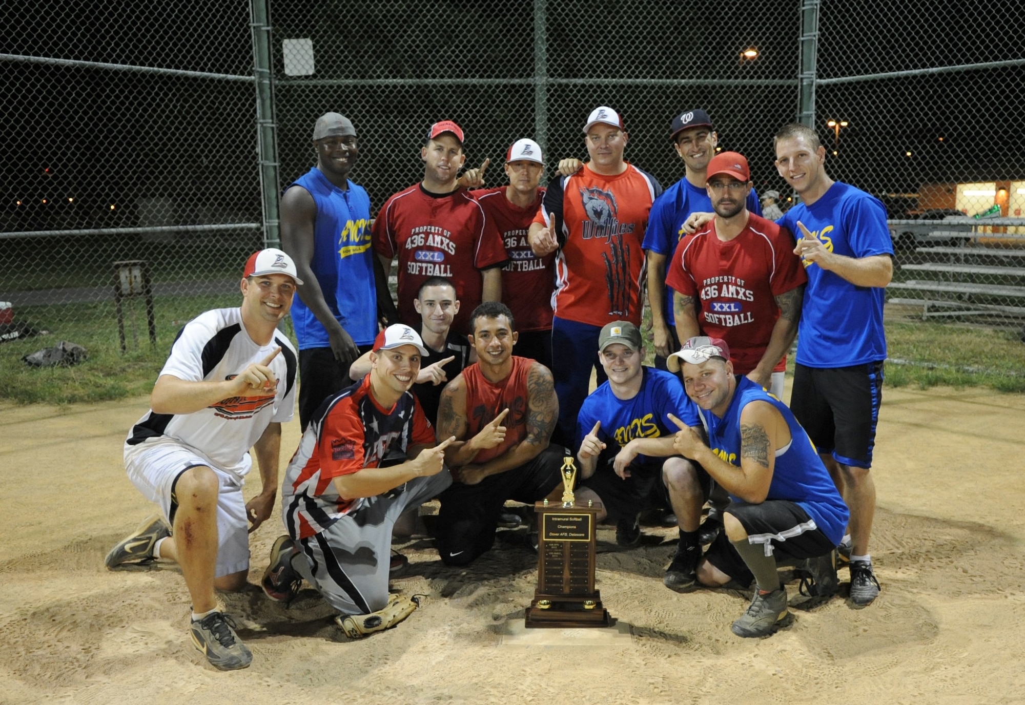 The 436th Aircraft Maintenance Squadron softball team poses with the championship trophy Sept. 4, 2013, at the softball field on Dover Air Force Base, Del. The 436th AMXS defeated the 373rd Training Squadron/Maintenance Operations Squadron to win the title. (U.S. Air Force photo/Staff Sgt. Elizabeth Morris)