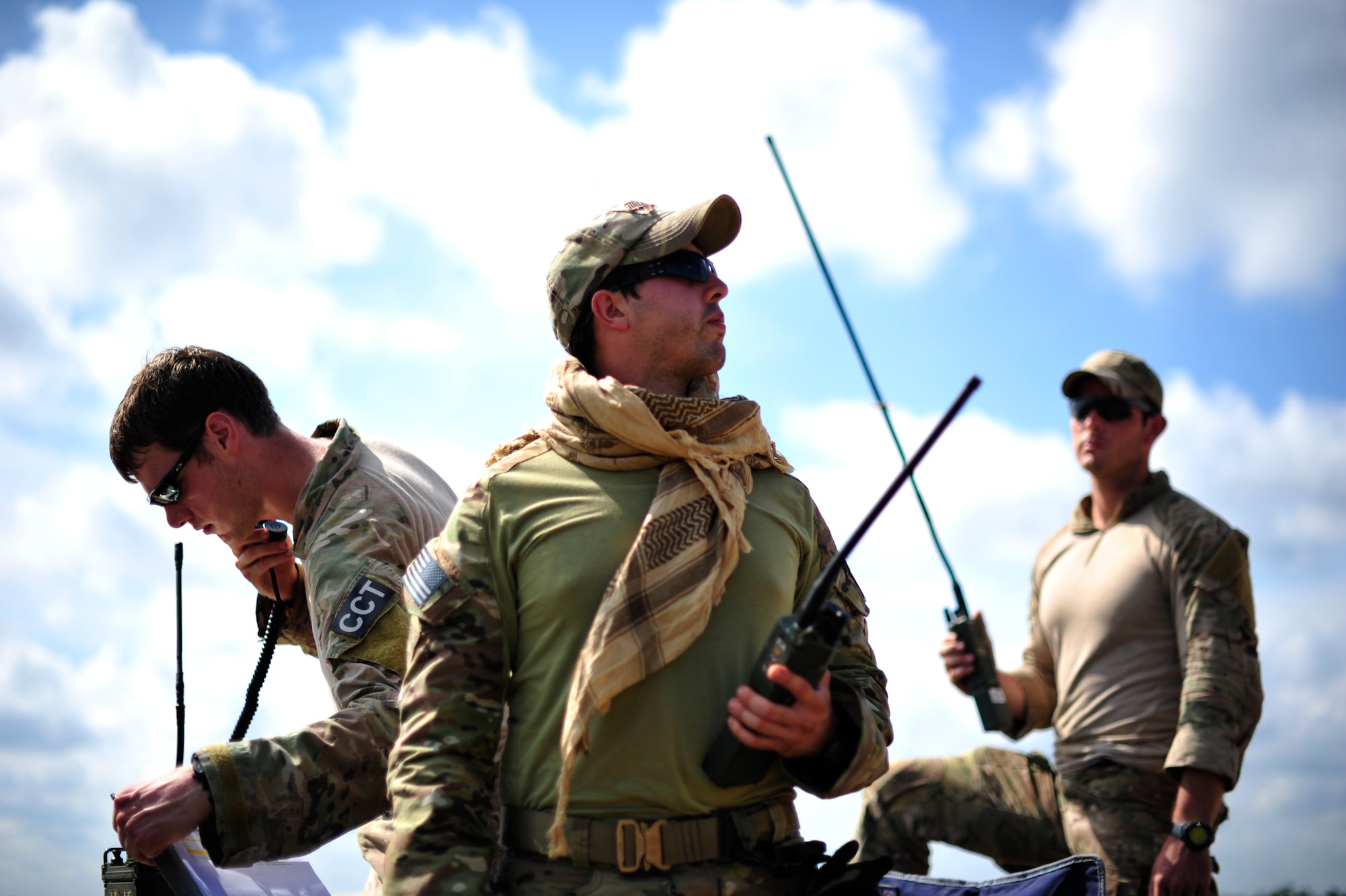 FORT POLK, La. – From left: Senior Airman Chase Litvan, Staff Sgt. Josh Arias and Staff Sgt. Will Doherty, U.S. Air Force combat controllers from the 21st Special Tactics Squadron, Fort Bragg, N.C. conduct air traffic control operations on the edge of the Geronimo Landing Zone at Fort Polk, La. during Joint Readiness Training Center rotation 13-09, Aug. 20, 2013. Combat controllers are special operations forces and certified FAA air traffic controllers whose mission is to deploy, undetected, into combat and hostile environments to establish assault zones or airfields, while simultaneously conducting air traffic control, fire support, command and control, direct action, counter-terrorism, foreign internal defense, humanitarian assistance, and special reconnaissance. (U.S. Air Force photo by Tech. Sgt. Parker Gyokeres)(Released)