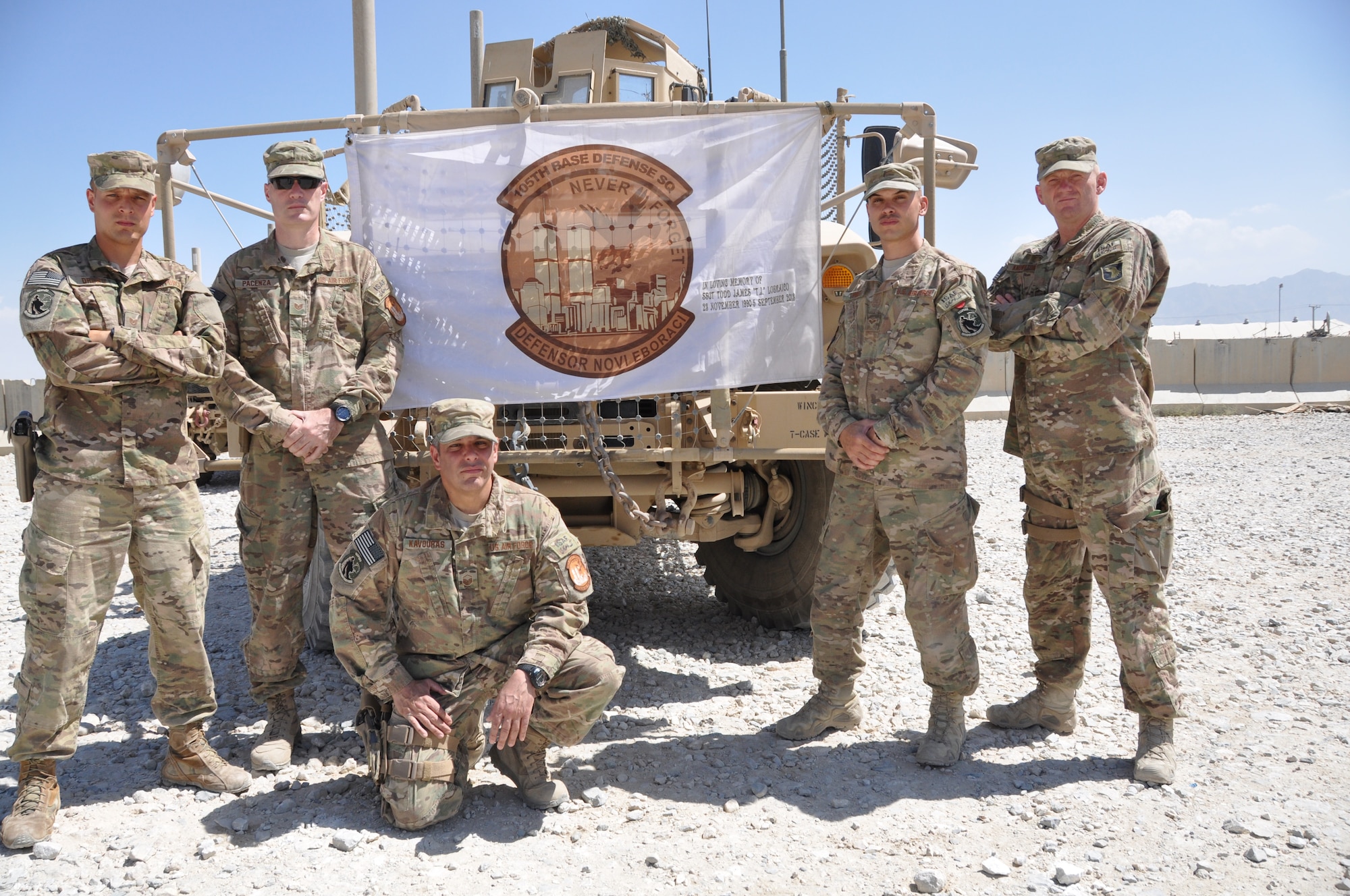 Tech. Sgt. Christopher Drews, 755th Expeditionary Security Forces Squadron 2nd in charge quick-reaction team 4, Tech. Sgt. Michael Pacenza, 755 ESFS Reaper 7 squad leader, Master Sgt. Anthony Kavouras, 755 ESFS Reaper 7 non-commissioned officer, Senior Airman Adrian Torres, 755 ESFS gunner 240 B for QRT4, and Master Sgt. Shawn Knowlton, 755 ESFS Reaper 4 squad leader, all deployed from the 105th SFS, Stewart Air National Guard Base, Newburgh, New York. Sept. 11 is never too far from the hearts and minds of the 105th SFS deployed here. Through mementos and each other, they remember one unit member who was killed during the attacks of Sept. 11, 2001. (U.S. Air Force photo/Tech. Sgt. Rob Hazelett)