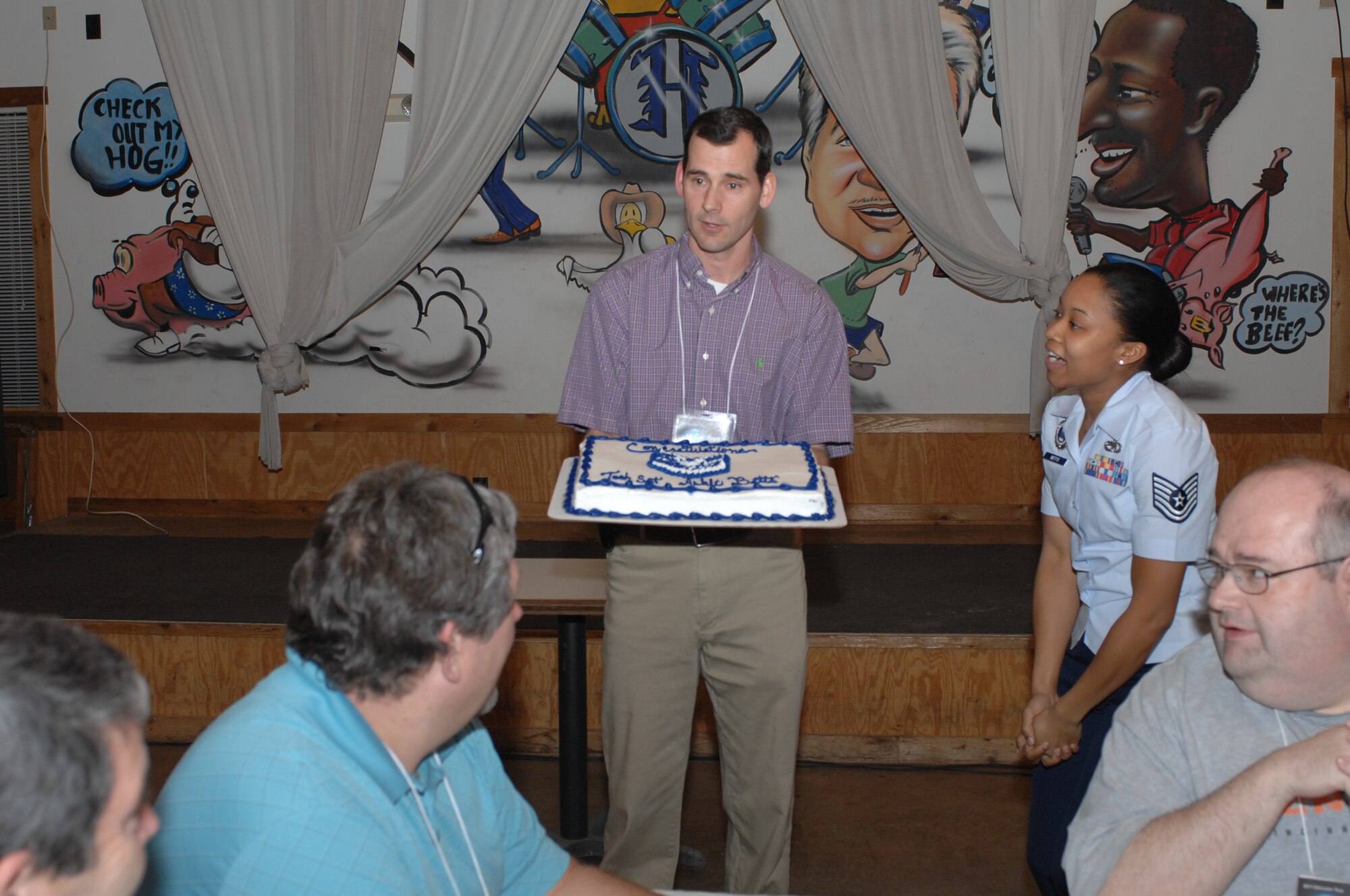Lt. Col. Brett Ashworth, 344th Recruiting Squadron commander, surprises Tech. Sgt. Ashli Betts, 344th RCS recruiter, with a promotion caked during a Distinguished Educator tour at a restaurant in Cibolo, Texas, March 2011. Betts enlisted in the Air Force Sept. 12, 2001 (U.S. Air Force photo/Staff Sgt. Hillary Stonemetz)