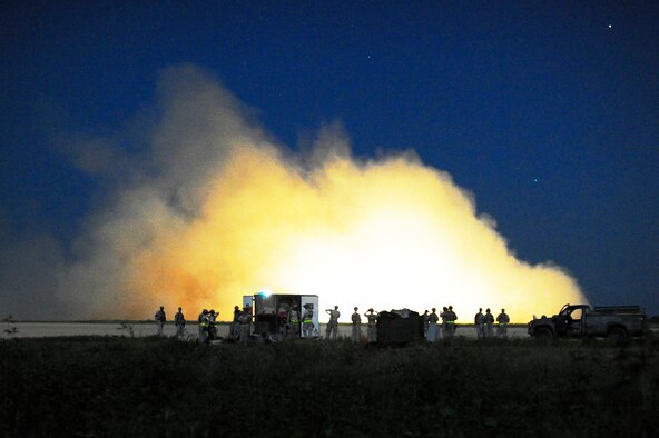 Airmen assigned to the 621st Contingency Response Wing, Travis Air Force Base, Calif., build their air mobility forward support base as a Canadian Royal Air Force C-130J Hercules stops in a cloud of dust at Geronimo Landing Zone on Fort Polk, La. during Joint Readiness Training Center rotation 13-09, Aug. 19, 2013. The CRW specializes in rapidly establishing air mobility support operations in disaster-stricken, austere or hostile environments in response to natural disasters or combat operations. (U.S. Air Force photo/Tech. Sgt. Parker Gyokeres)