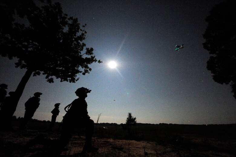 FORT POLK, La. – U.S. Army infantrymen assigned to Bravo Company, 2nd Battalion, 505th Parachute Infantry Regiment, 82nd Airborne Division from Fort Bragg, N.C., wait in the darkness at the Geronimo Drop Zone on Fort Polk during a mass airdrop that began the ground combat phase of Joint Readiness Training Center rotation 13-09, Aug. 18, 2013. The Soldiers were prepositioned to link up with the airdropping forces and begin the buildup of forces.  (U.S. Air Force photo by Tech. Sgt. Parker Gyokeres)(Released)