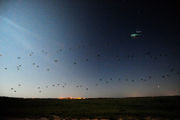 Army paratroopers assigned to the 3rd Brigade, 82nd Airborne Division from Fort Bragg, N.C., descend in the darkness onto the Geronimo Drop Zone at Fort Polk as part of a mass airdrop that began the combat phase of Joint Readiness Training Center rotation 13-09, Aug. 18, 2013. The Soldiers were responsible for taking and holding the airfield on Geronimo so aircraft could begin delivering heavy supplies and equipment. (U.S. Air Force photo/Tech. Sgt. Parker Gyokeres)